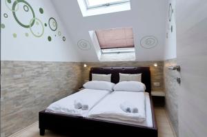 a bedroom with a bed with two stuffed animals on it at Flatprovider - Manuela Apartment Vienna in Vienna
