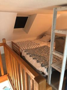a bedroom with a bunk bed and a ladder at Charmant duplex avec belle vue mer la plage à 100 m in Saint-Nic