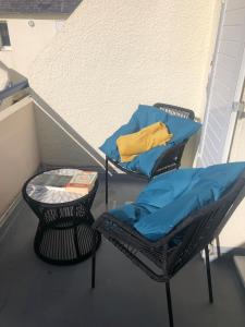 a balcony with a bed and a chair and a pillow at Charmant duplex avec belle vue mer la plage à 100 m in Saint-Nic +26 photos