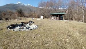 a group of animals laying in a field next to a building at CASA Petra in Bituše