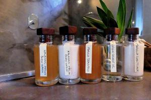 a group of four bottles of honey on a counter at Casa Babi in Vilanculos