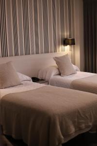 Postel nebo postele na pokoji v ubytování New Hotel Colon
