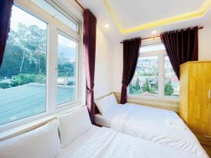 Postel nebo postele na pokoji v ubytování Hoa Chuông Villa Đà Lạt
