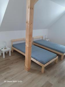 two bunk beds with blue sheets in a room at Chata AmBach in Liberk
