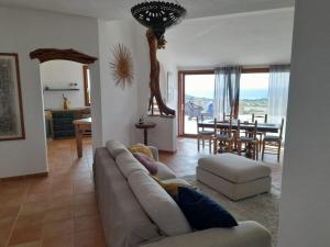 a person laying on a couch in a living room at Villa Ibisco in Chia