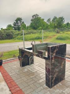 a concrete sink in a yard with a fence at Pearl Villa 5 Bedroom Unit 1 in Port Dickson