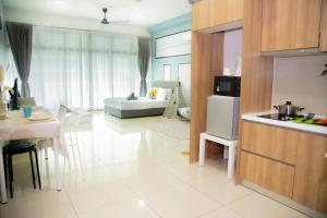 a kitchen and living room with a couch and a table at Mount Austin IKEA, AEON 10mins -Pool View- B122 in Johor Bahru
