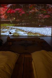 a bedroom with a large painting on the wall at TEIEN stay sauna in Ōtani