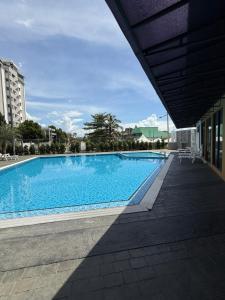 a large blue swimming pool in a building at The Barakat Homestay in Semenyih