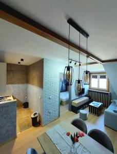 a living room with a couch and a table at VS Apartman , Hotel Župa Kopaonik in Kopaonik +9 photos