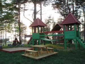a playground with two play structures and a table and benches at Selena 2003 in Kaunata