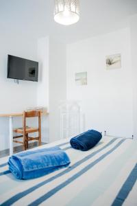 two blue pillows sitting on top of a bed at Villa Serenita in Villemoustaussou +37 photos