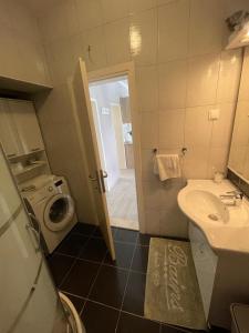 a bathroom with a sink and a washing machine at Villa Norah in Podgora +82 photos