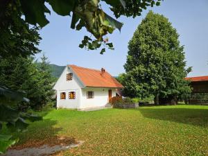 a small white house with an orange roof at Mežnarija - Cerovec in Dolenjske Toplice