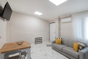 a living room with a couch and a table at Alloggio turistico metro C in Borghesiana 