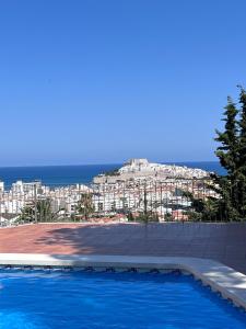 a swimming pool with a view of a city at El Wappo in Peñíscola