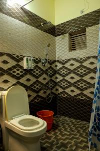 a bathroom with a toilet and a shower at Kunnumpurathu Holidays & Homestay in Kottayam