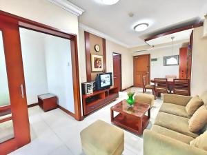 a living room with a couch and a tv at Large 3BR Cieumbuluit Apt Near PVJ & Ciwalk by 2ndHome in Bandung