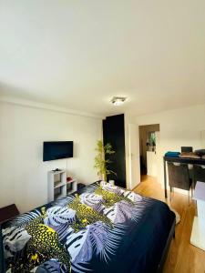 a bedroom with a bed in a room with a desk at Maison au coeur du Sidobre in Saint-Salvy-de-la-Balme +3 photos