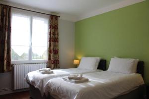 Postel nebo postele na pokoji v ubytování Le Clos Castel