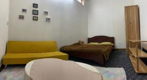 a bedroom with two beds and a couch at Ngọc Am homestay in Hanoi +4 photos