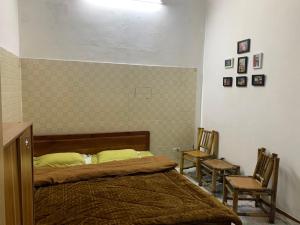 a bedroom with a bed and two chairs at Ngọc Am homestay in Hanoi