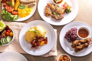 a group of plates of food on a table at Carlton Hotel Bangkok Sukhumvit in Bangkok