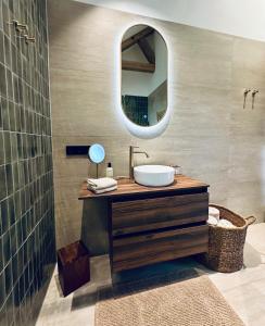 a bathroom with a sink and a mirror at Landhuisje ter Heide - charming cottage with hottub in De Moer +30 photos