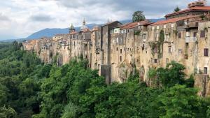 a large building on the side of a mountain at Filocase Comfortable Hideout in SantʼAgata deʼ Goti
