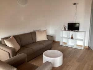 a living room with a couch and a tv at R&B La Calzoleria in Mori