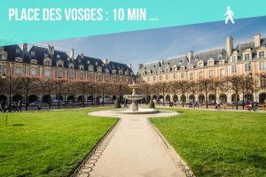 a park with a fountain in front of a large building at Ômarais Guest House in Paris