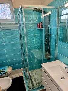 a bathroom with a shower and a sink at Apartman Roberto in Hajdúszoboszló +19 photos