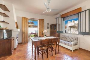a living room with a table and a couch at villa simona by salentolimit in Isola della Malva
