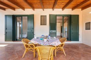 a dining room table with chairs and a tablecloth at villa simona by salentolimit in Isola della Malva +18 photos