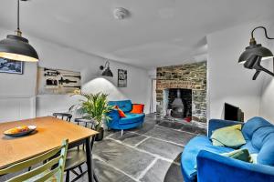 a living room with blue furniture and a fireplace at Finest Retreats - Bre Stefan in Launceston