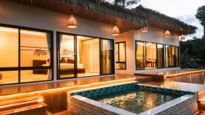 a house with a pool in front of it at PHULAYYA CHIANGMAI - Pool Villa House in Ban Kai Noi