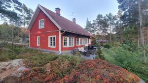 a red house in the middle of a forest at Villa Markomby in Markomby