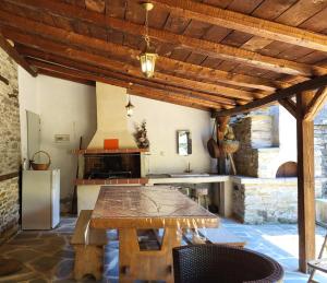 a kitchen with a wooden table and a refrigerator at Rustic House in Eleftheroúpolis