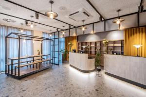an office with a lobby with a reception desk and tables at NH Hamburg Altona in Hamburg