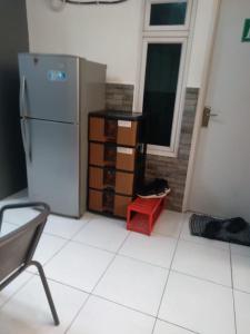 a kitchen with a refrigerator and a window at Mgd kos syariah Sentul in Citaringgul 1