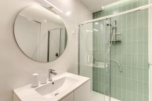 a bathroom with a sink and a shower with a mirror at ArtPartment in Naples