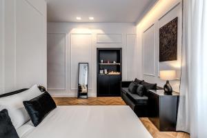 a bedroom with a white bed and a couch at ArtPartment in Naples