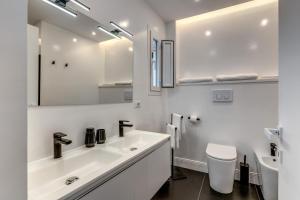 a white bathroom with a sink and a toilet at ArtPartment in Naples