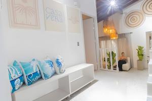 a man sitting on a couch in a white room at Chill-Out | Jacuzzi todo el año | Unicentro 5 minu in Medellín