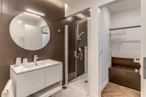 a bathroom with a shower and a sink and a mirror at ArtPartment in Naples