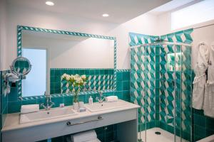 a bathroom with a sink and a mirror at Grand Hotel Tritone in Praiano