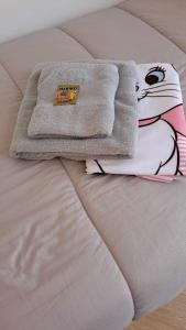 a pile of towels on top of a bed at Casa Marie in Marina di Modica