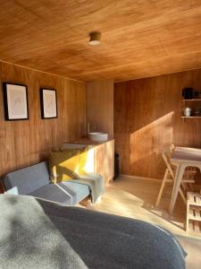 a living room with a couch and a table at Cross Farm Retreat in Todmorden