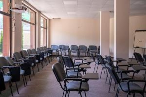 an empty room with chairs and a whiteboard in a classroom at Tryavna Lake Hotel & SPA in Tryavna +72 photos