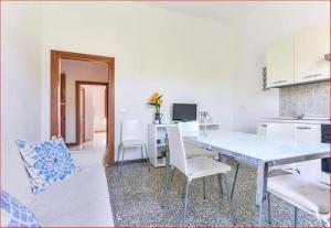 a kitchen and dining room with a table and chairs at Casa Martina a Porto Azzurro in Porto Azzurro +2 photos